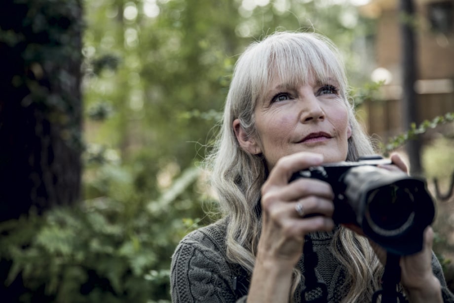 The Falls Estate - woman taking photographs of the bushland surrounds