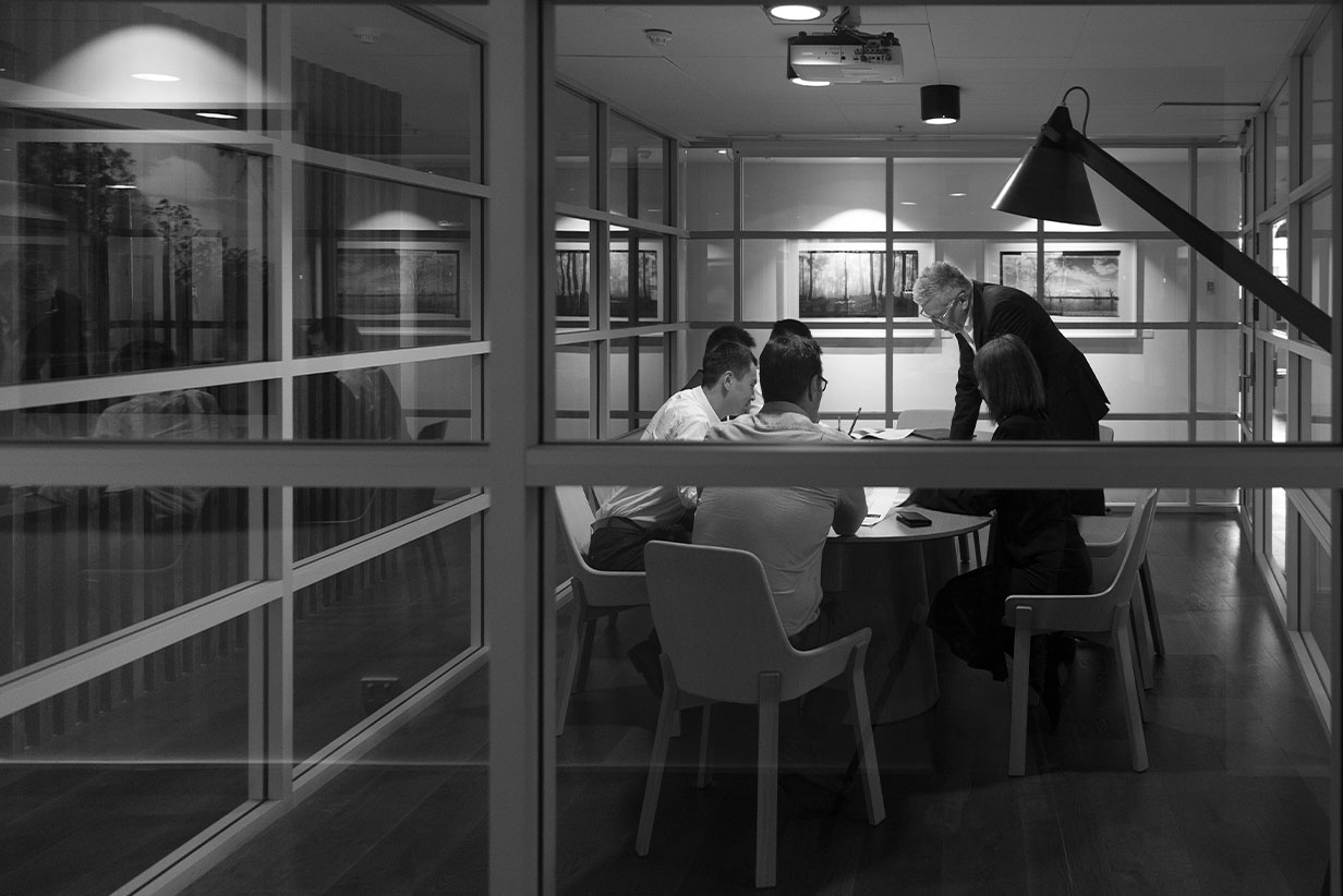 One Fell Swoop - people in a meeting around a boardroom table
