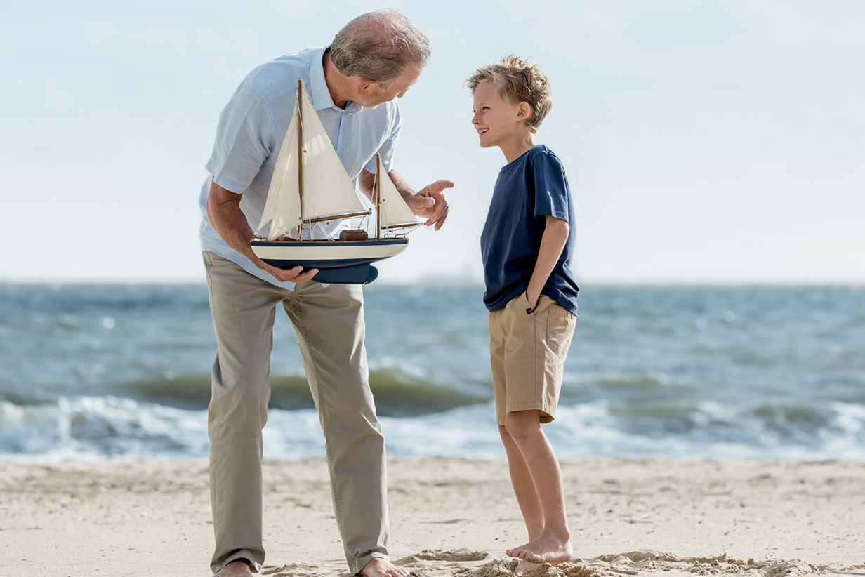 One Fell Swoop - senior man with boy on beach