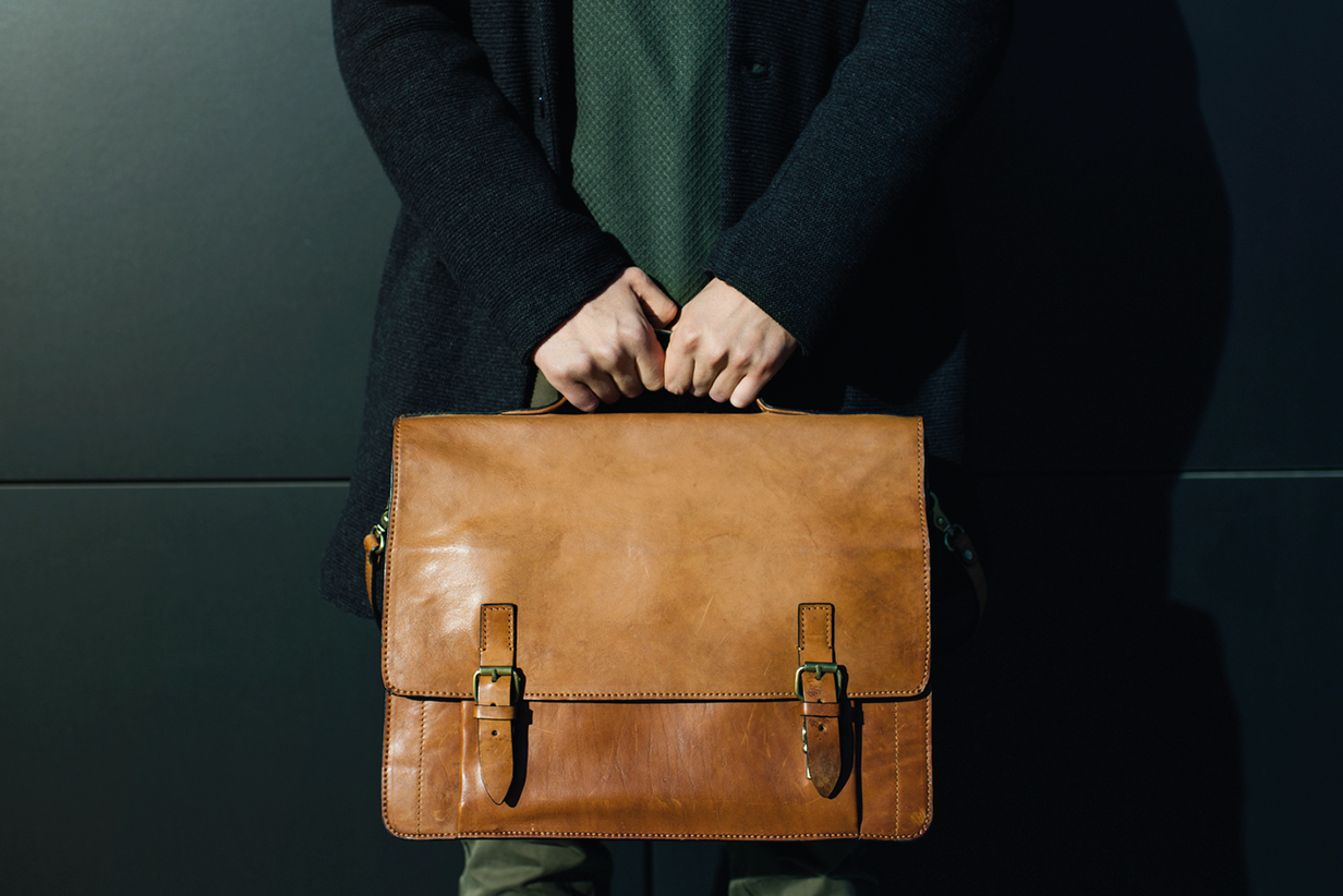 One Fell Swoop - man holding a leather satchel briefcase
